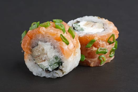 Salmon rolls with eel, green onion and cucumber