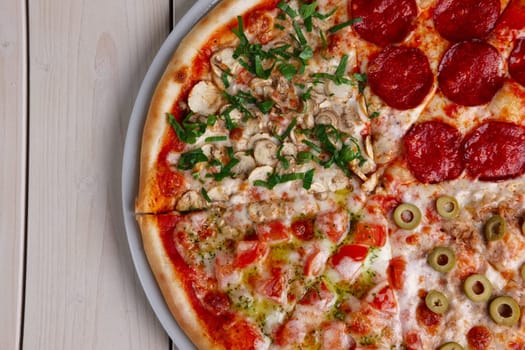 Top view of pizza four seasons. Copy-space place.