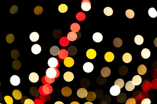 Abstract colorful bokeh light effects on the night black background texture