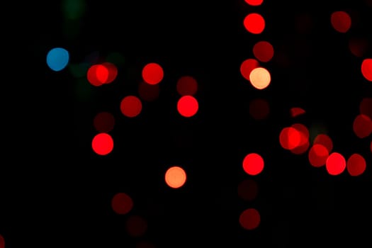 Red Abstract bokeh light effects on the night black background texture
