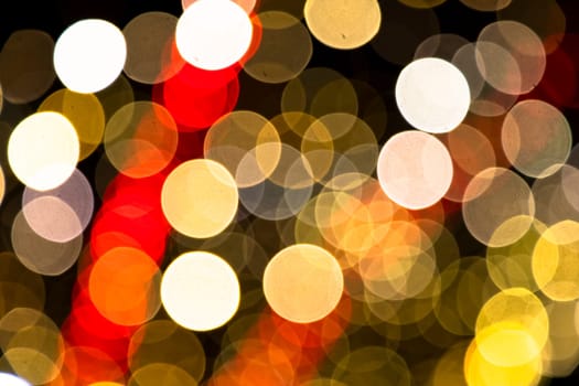 Abstract colorful bokeh light effects on the night black background texture