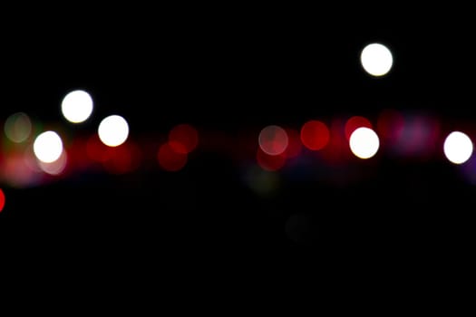 Abstract colorful bokeh light effects on the night black background texture