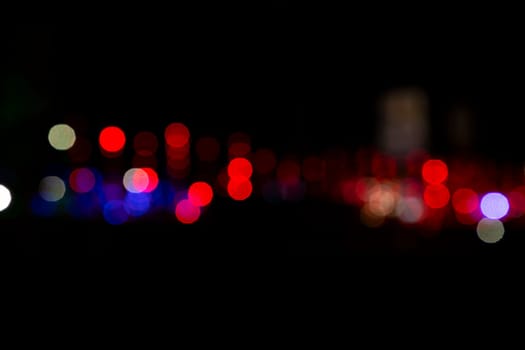 Abstract colorful bokeh light effects on the night black background texture