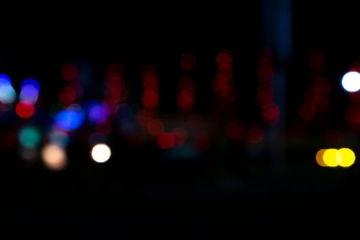 Abstract colorful bokeh light effects on the night black background texture