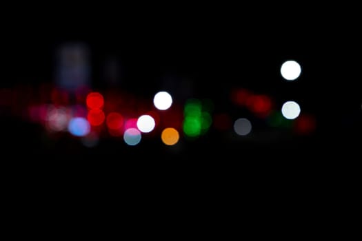 Abstract colorful bokeh light effects on the night black background texture