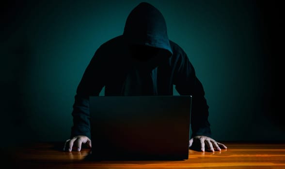 Hackers work on laptops in the dark. The concept of information security in the Internet network and information espionage.