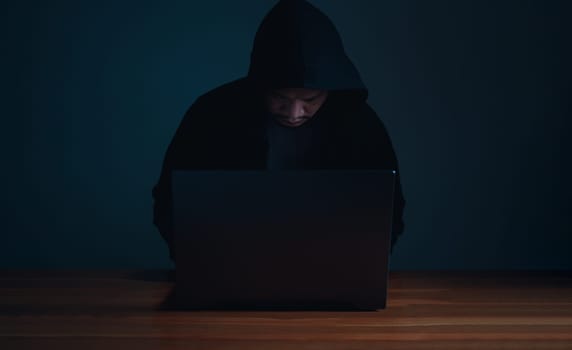 Hackers work on laptops in the dark. The concept of information security in the Internet network and information espionage.