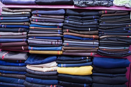 Patterned Textile Fabrics  stacked on a retail Shop Shelf for sale