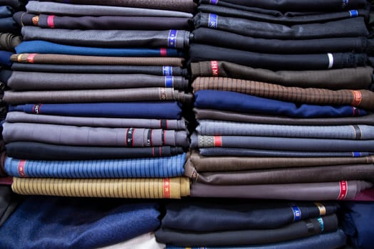 Patterned Textile Fabrics  stacked on a retail Shop Shelf for sale