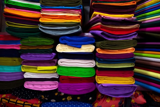 Artistic variety shade tone colors Textile Fabrics stacked on retail Shop Shelf to sale