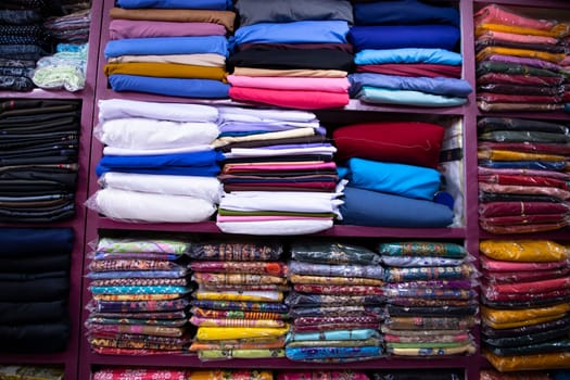 Patterned Textile Fabrics  stacked on a retail Shop Shelf for sale