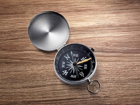 compass on the brown wooden table background