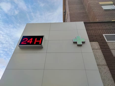 24-hour pharmacy wall. Building attached to apartment block