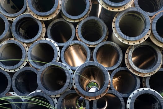Background of black plastic Rubber pipes used at the River Dressing. Light through tubes