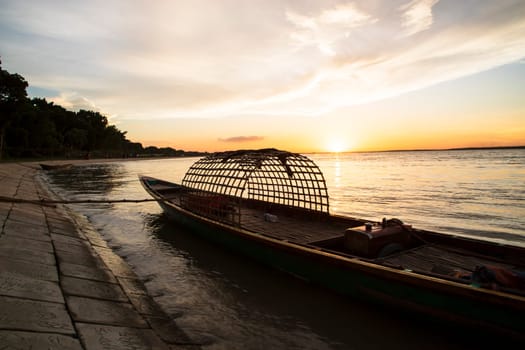 A wooden boat On Sea Against  Sky During Sunset
