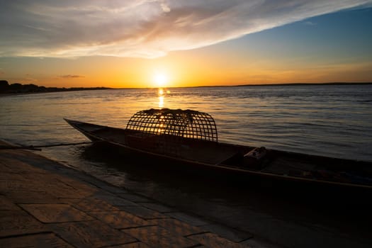 A wooden boat On Sea Against  Sky During Sunset