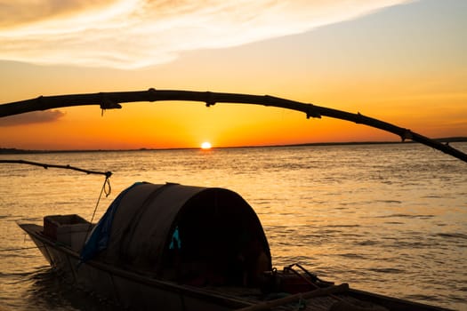 A wooden boat On Sea Against  Sky During Sunset