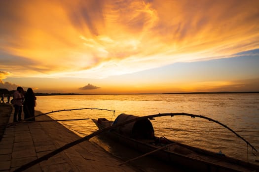 A wooden boat On Sea Against  Sky During Sunset