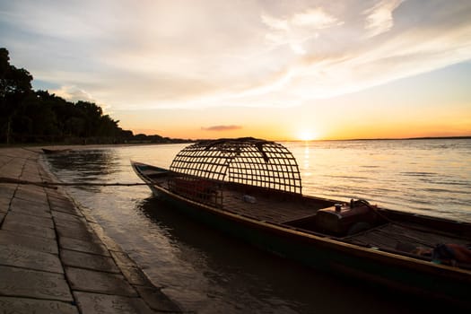 A wooden boat On Sea Against  Sky During Sunset