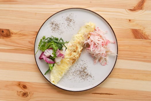 Omelette with crab meat and salad