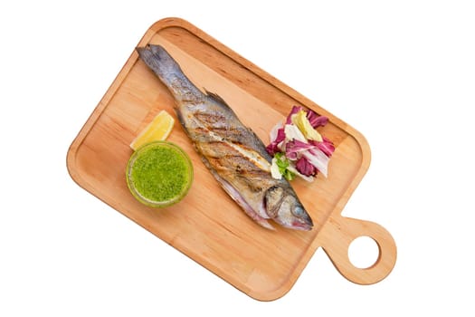 Whole fried fish on wooden board