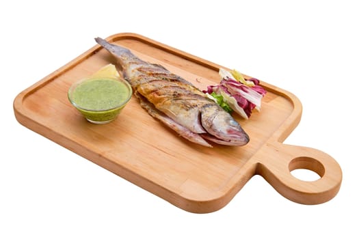 Whole fried fish on wooden board
