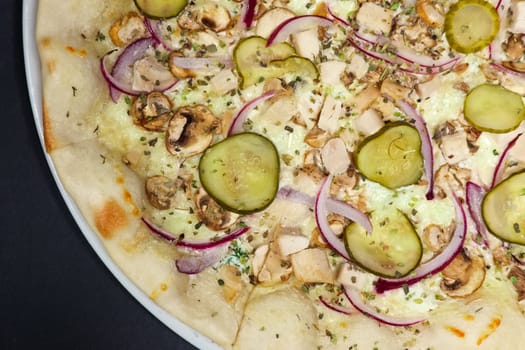 pizza with champignon, chicken and pickled cucumber and red onion