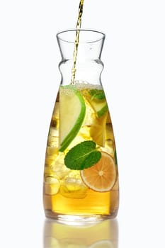 Filling up the jar with icy apple and orange drink with mint flavour.