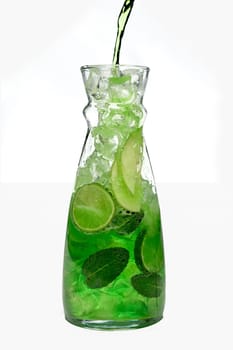 Filling up the jar with icy apple and lemon drink.