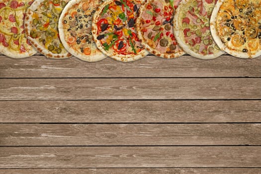 Horizontal collage of different baked pizzas on dark wooden table. Top view.
