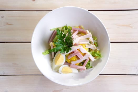Country salad with egg, ham, chicken fillet and vegetables