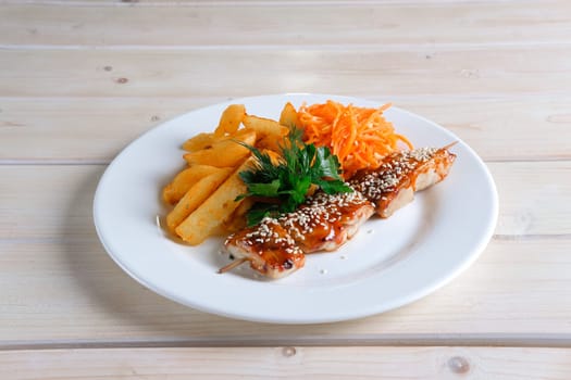Chicken shashlik with fried potato and spicy carrit
