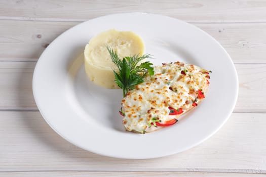 Fried chicken fillet with bell pepper, zucchini, melted cheese and mashed potato