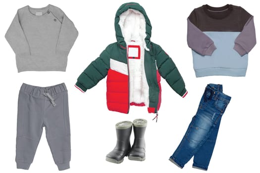 Collage little boy clothes, Set of a stylish down jacket, jeans, sport or sweatpants, boots and a sweater or cardigan isolated. Spring, autumn and winter fashion.