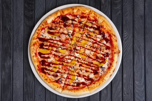 Top view of pizza with chicken, plum and barbecue sauce