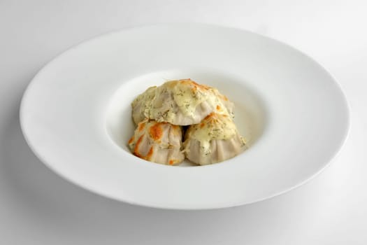 Deep plate with fried pelmeni with cheese