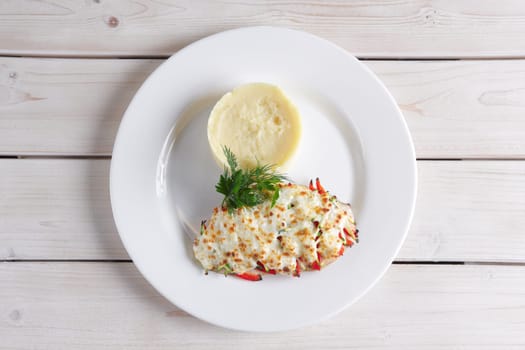Fried chicken fillet with bell pepper, zucchini, melted cheese and mashed potato