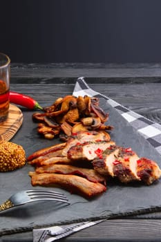 Fried pork fillet with mushrooms and slices of bacon served with pepper moonshine. Unhealthy but so tasty country food.