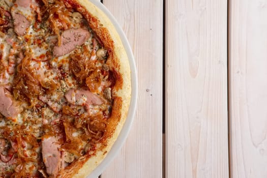 Freshly baked pizza with beef and fried onion