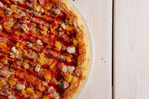 Pizza with chicken, pineapple, cheese and barbecue sauce