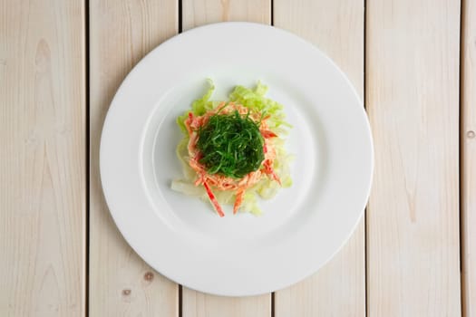 Salad with fresh cabbage, carrot, pepper and seaweed. Top view of vegetarian salad.