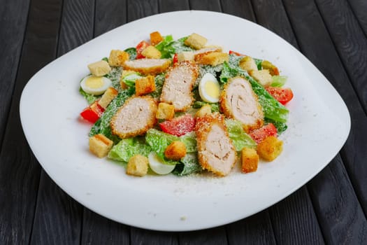 Salad with quail egg, fried chicken fillet and vegetables with cheese