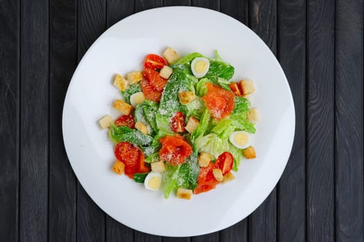 Top view of salad with quail egg, salmon fillet and vegetables with cheese