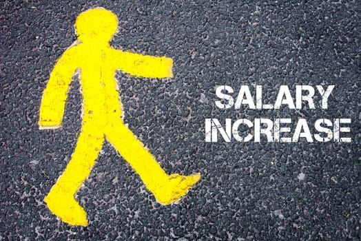 Yellow pedestrian figure on the road walking towards  SALARY INCREASE. Conceptual image with Text message over asphalt background.