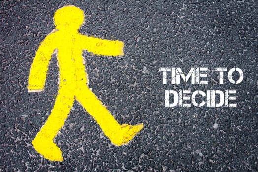 Yellow pedestrian figure on the road walking towards TIME TO DECIDE. Conceptual image with Text message over asphalt background.