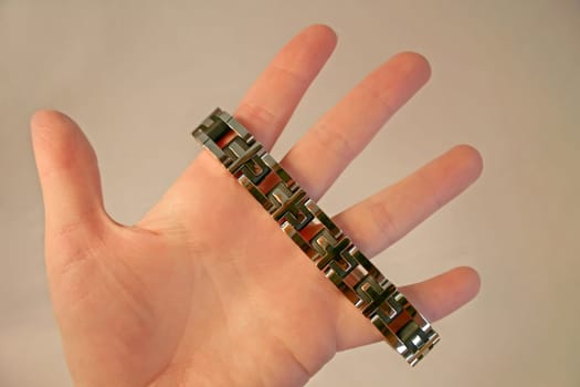 A piece of jewelry, a bracelet, on a hand.