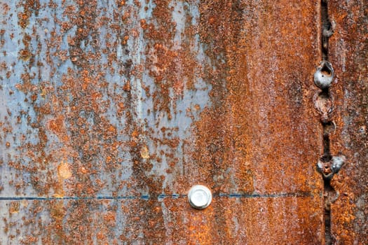 scratched and rusty orange metal surface as background