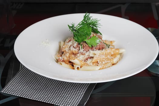 Pasta with tuna and cheese on the table.