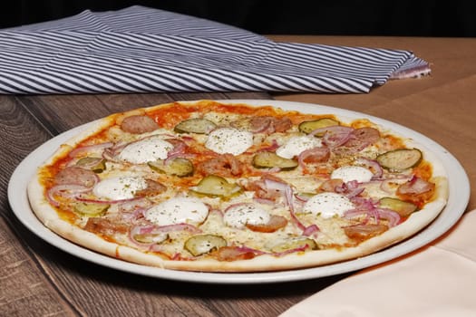 Pizza with bacon and onion on wooden table