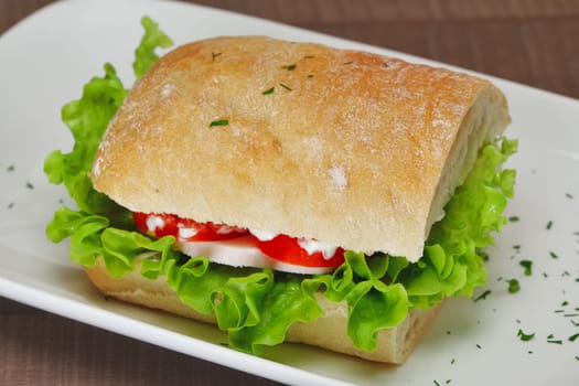 Ciabatta panini sandwich with chicken and tomato. Sandwich stuffed with sausage, egg and tomato.